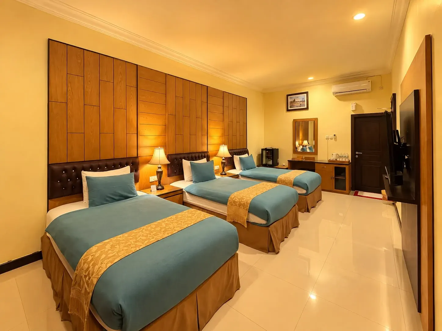 Deluxe Triple dengan tiga tempat tidur sejajar.